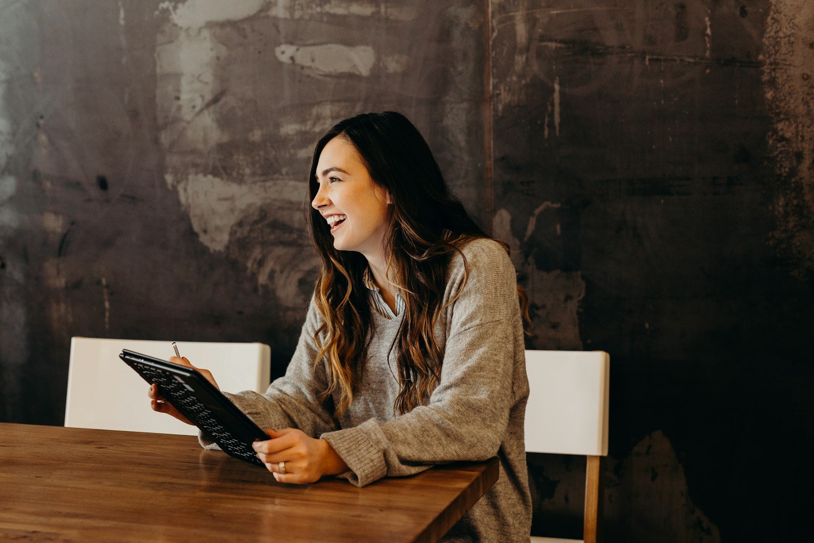 Entrepreneur smiling while working on a tablet